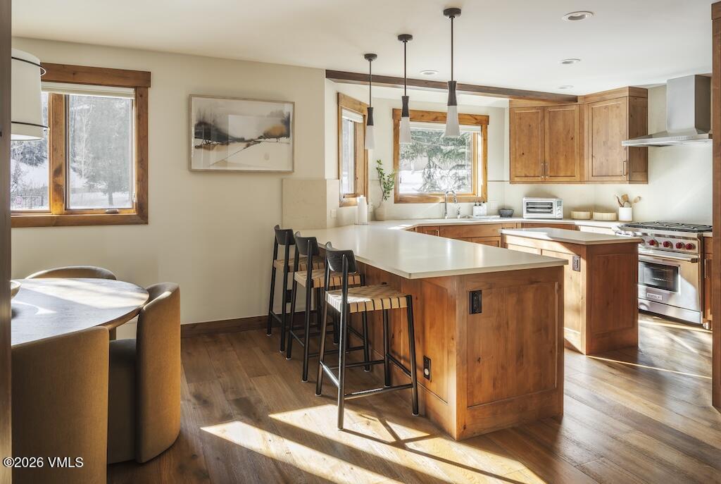 1670 Fallridge Place, Unit 9 Vail, CO 81657 - Photo 19 of 39 a kitchen with stainless steel appliances granite countertop a stove a sink dishwasher and a refrigerator with wooden floor
