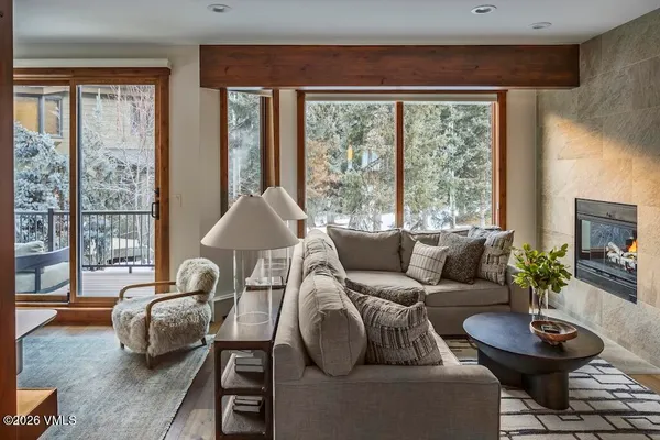 a living room with furniture and a potted plant