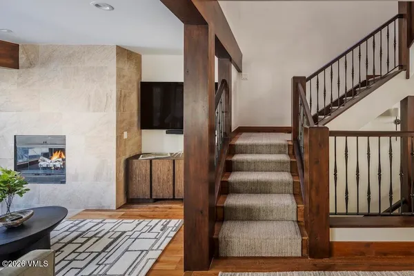 a view of a hallway with wooden floor and entryway