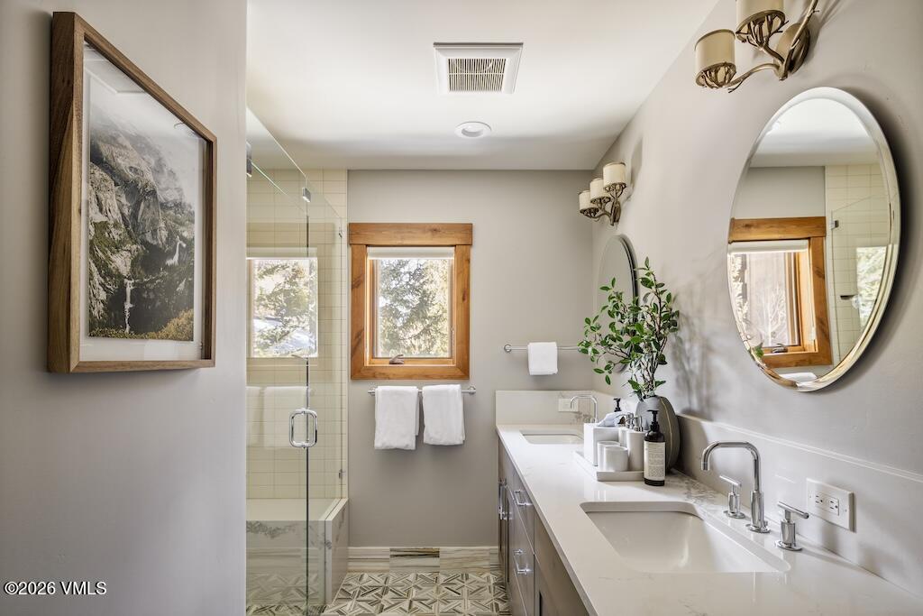 1670 Fallridge Place, Unit 9 Vail, CO 81657 - Photo 29 of 39 a bathroom with a tub sink and mirror