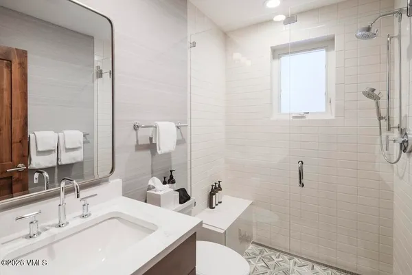 a bathroom with a sink toilet and shower