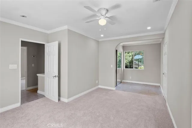 an empty room with a ceiling fan and a window
