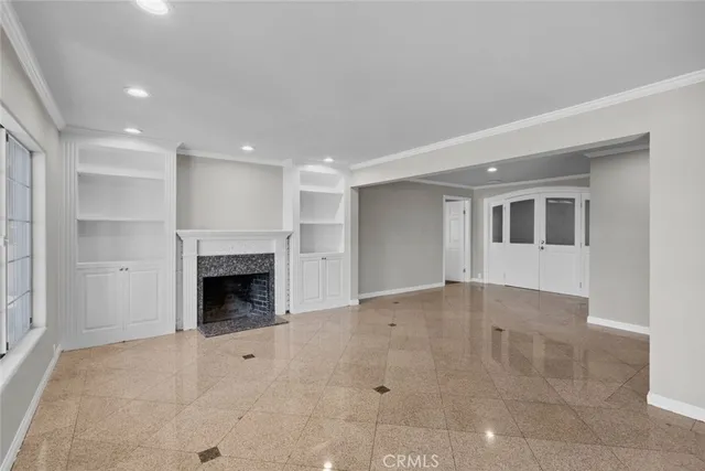 a view of an empty room with a fireplace