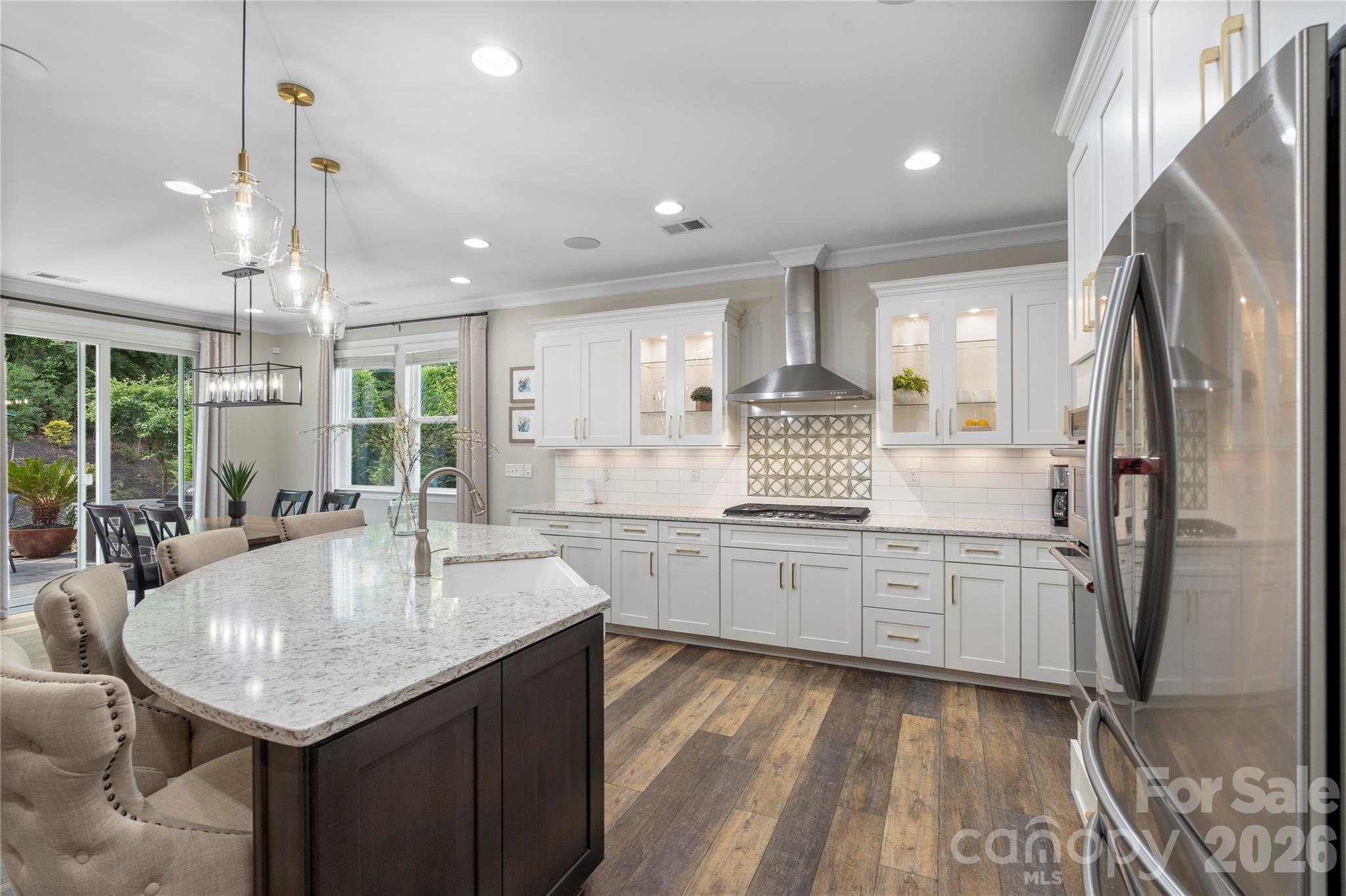 445 Sandbar Point Clover, SC 29710 - Photo 12 of 48 a kitchen with center island white cabinets and stainless steel appliances