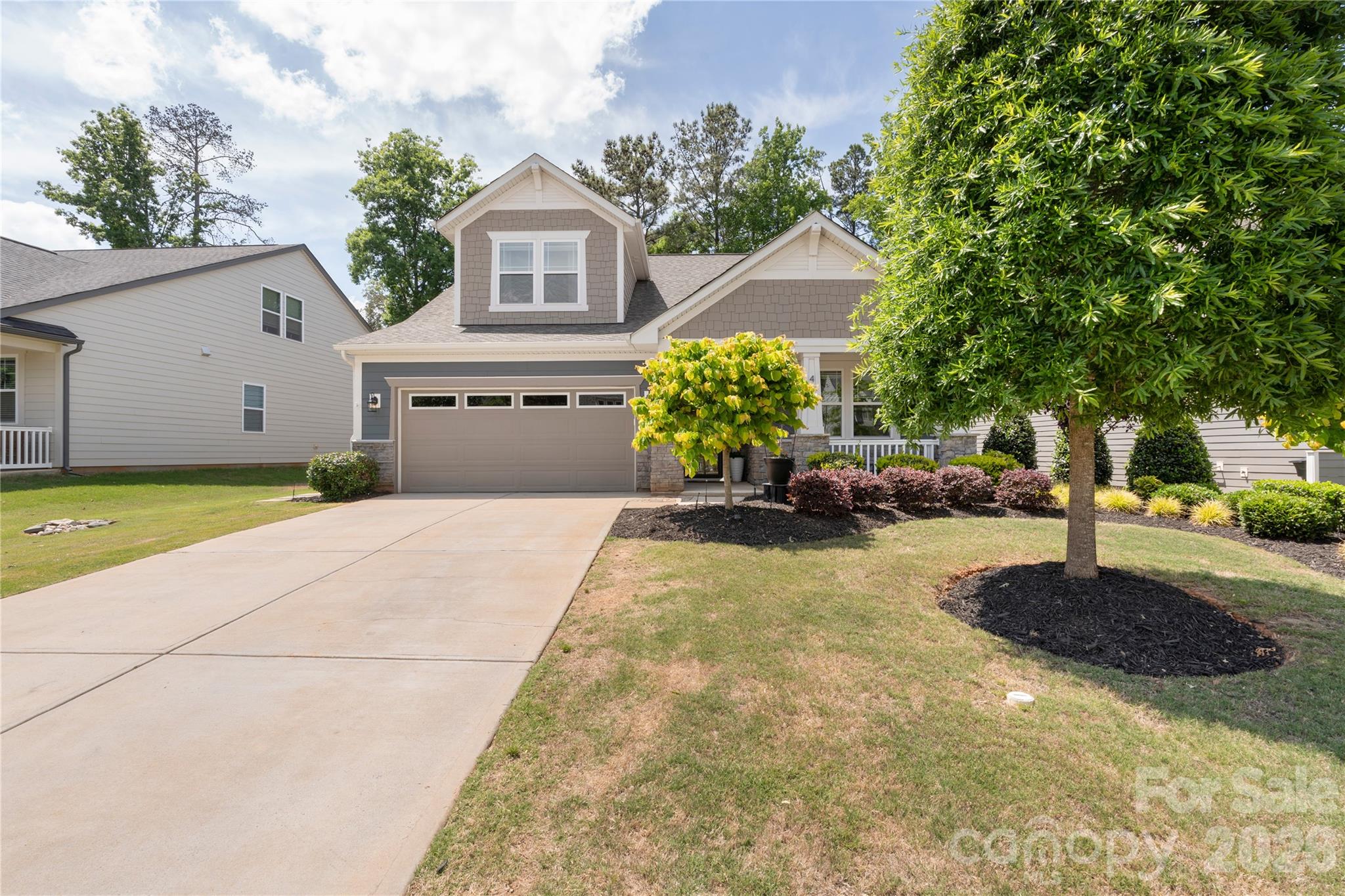 445 Sandbar Point Clover, SC 29710 - Photo 2 of 48 a front view of a house with a yard and a garage