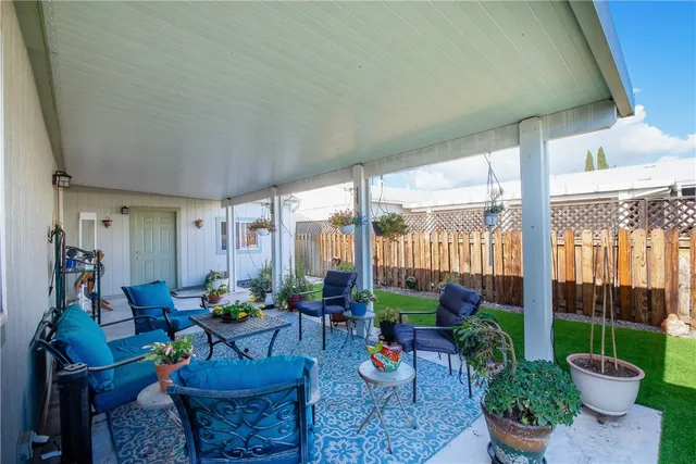 a living room filled with furniture and a potted plant