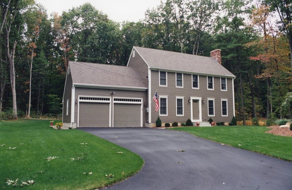 527 Old County Road Holland, MA 01521 - Photo 2 of 17 a front view of a house with a garden and trees