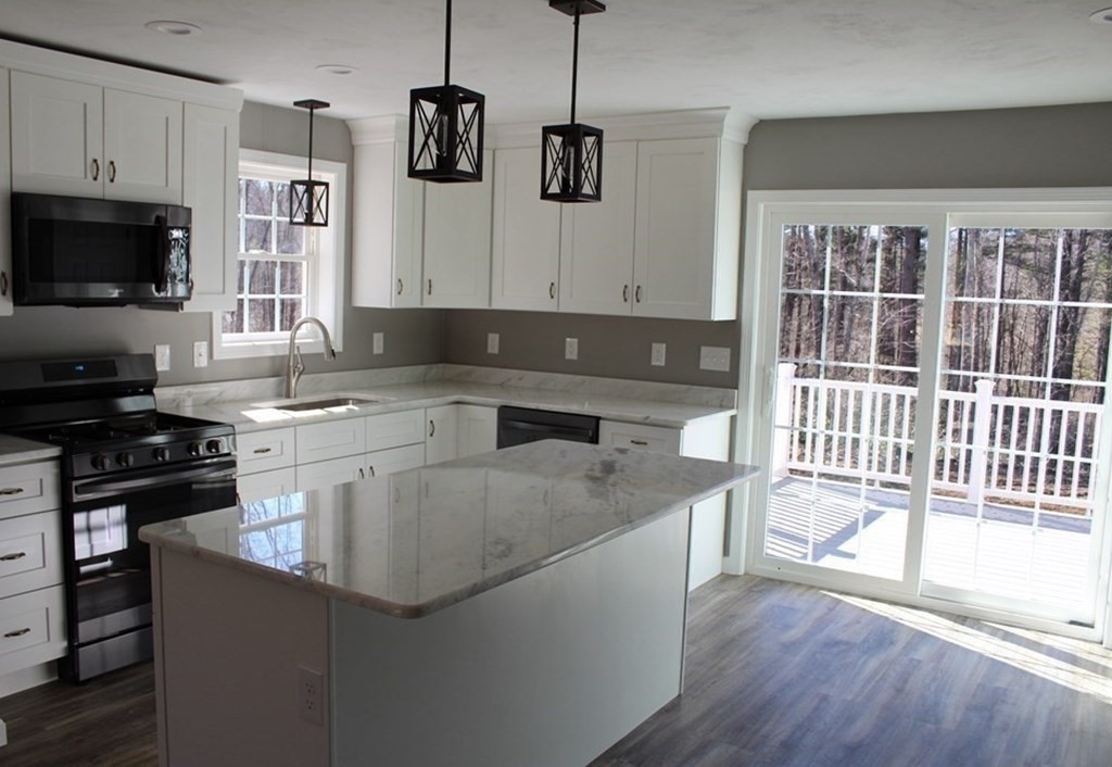 527 Old County Road Holland, MA 01521 - Photo 7 of 17 a kitchen with granite countertop a stove a sink and a microwave