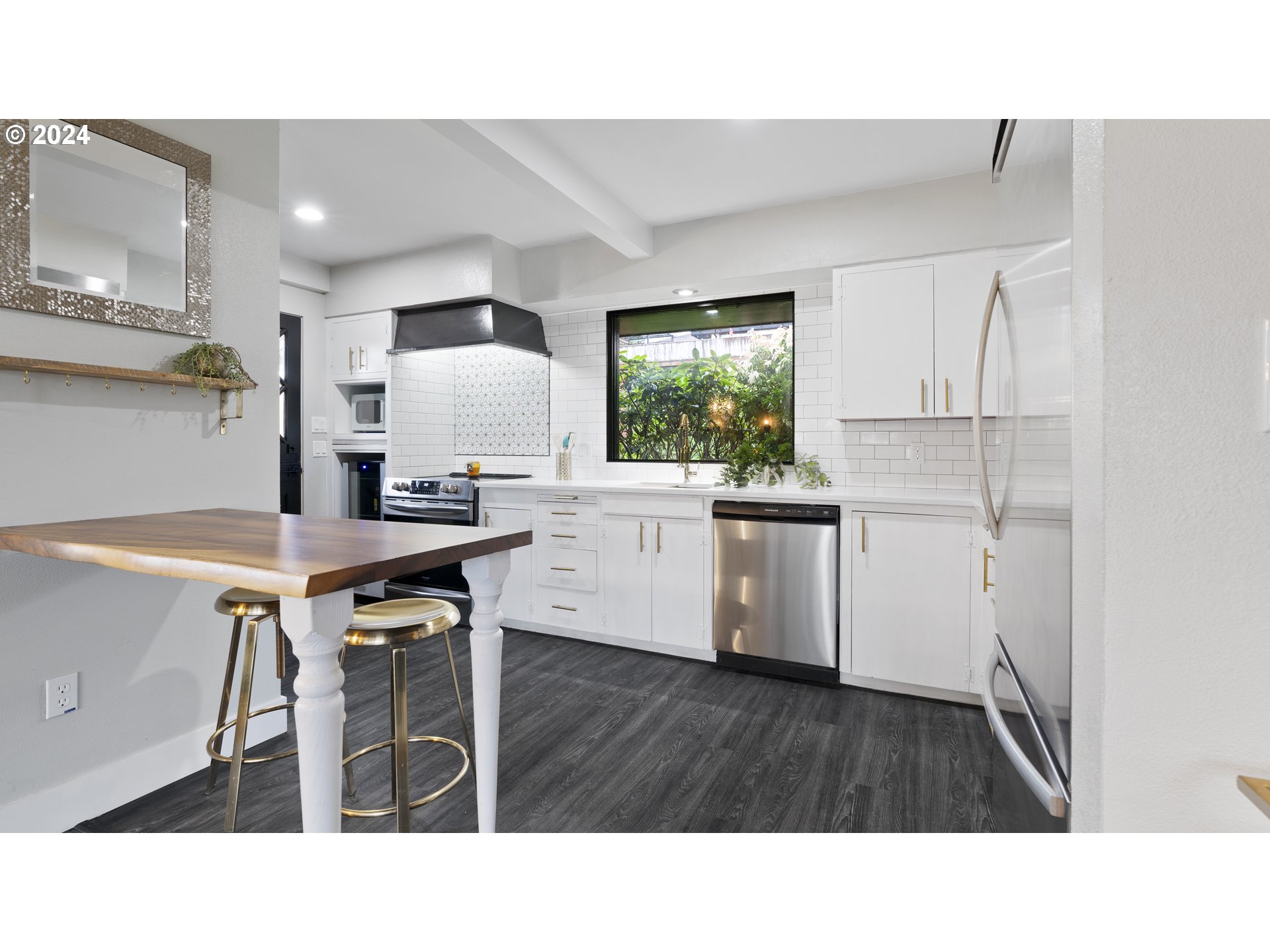 1160 North 10th Street Coos Bay, OR 97420 - Photo 15 of 42 a kitchen with kitchen island a stove a table and chairs