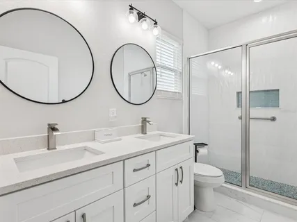 a bathroom with a toilet a sink and a mirror