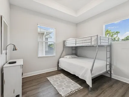 a bedroom with a bed and wooden floor
