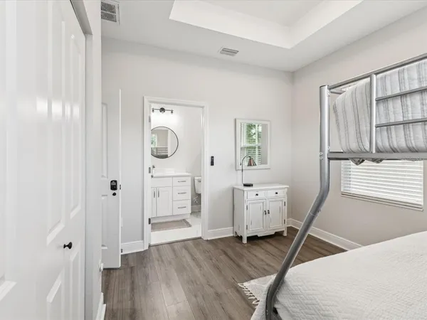 a room with a wooden floor and white walls