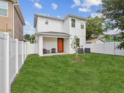 a backyard of a house with table and chairs