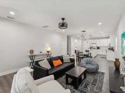a living room with furniture and wooden floor