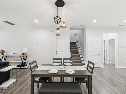 a view of a dining room with furniture and wooden floor