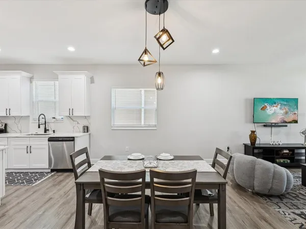 a view of a dining room with furniture and wooden floor