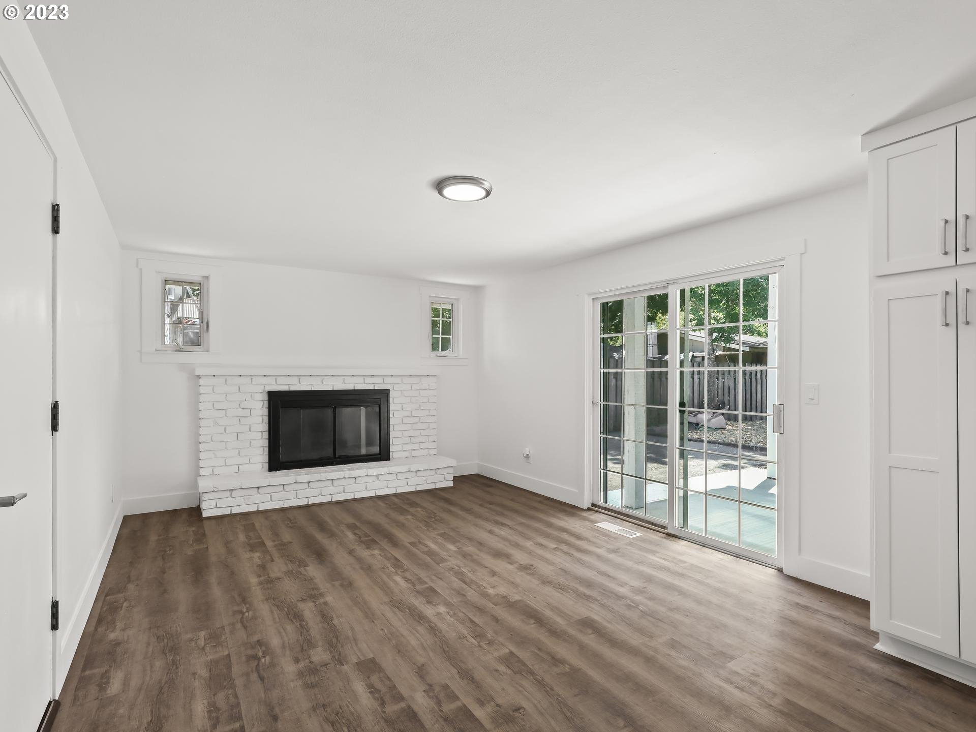 19650 Southwest Celebrity Street Beaverton, OR 97078 - Photo 13 of 47 an empty room with wooden floor and fireplace