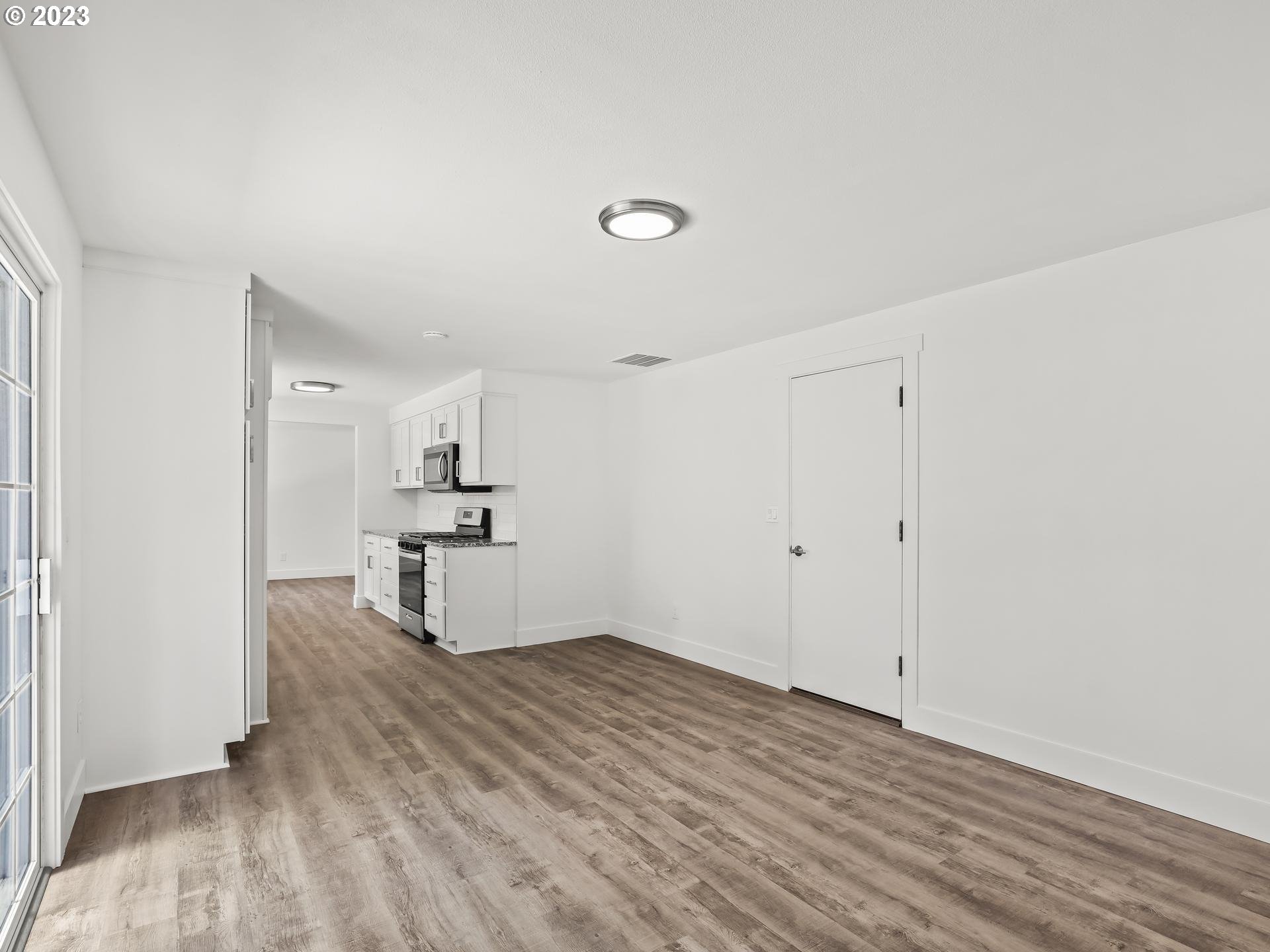 19650 Southwest Celebrity Street Beaverton, OR 97078 - Photo 15 of 47 a view of a kitchen with wooden floor and a sink