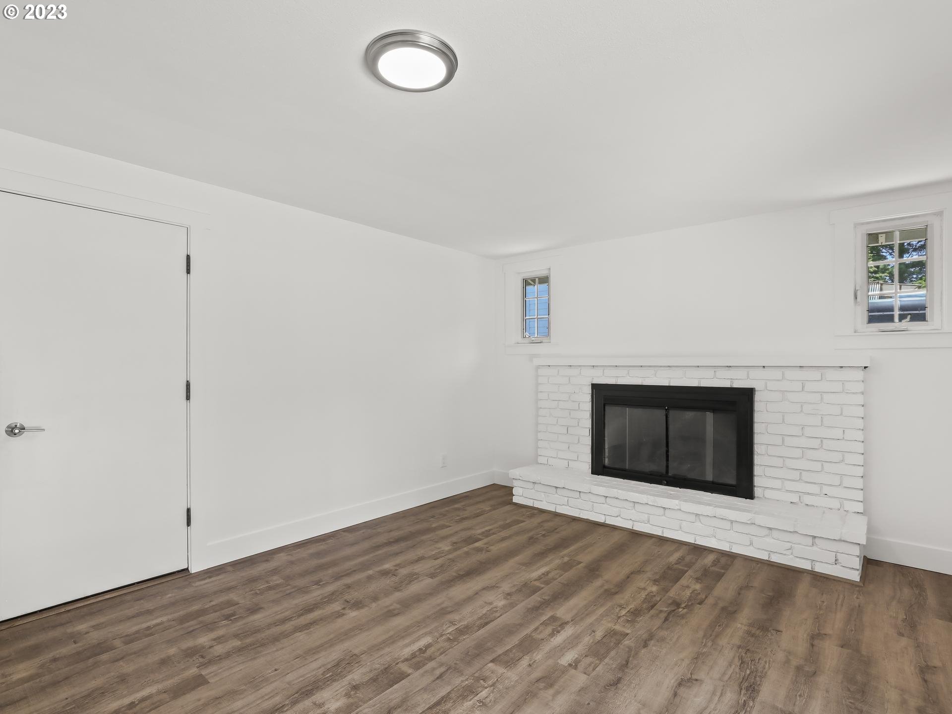 19650 Southwest Celebrity Street Beaverton, OR 97078 - Photo 16 of 47 an empty room with wooden floor and fireplace