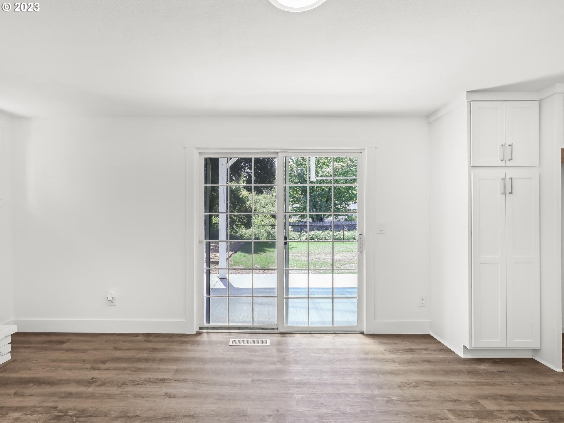 19650 Southwest Celebrity Street Beaverton, OR 97078 - Photo 17 of 47 a view of an empty room with wooden floor and a window