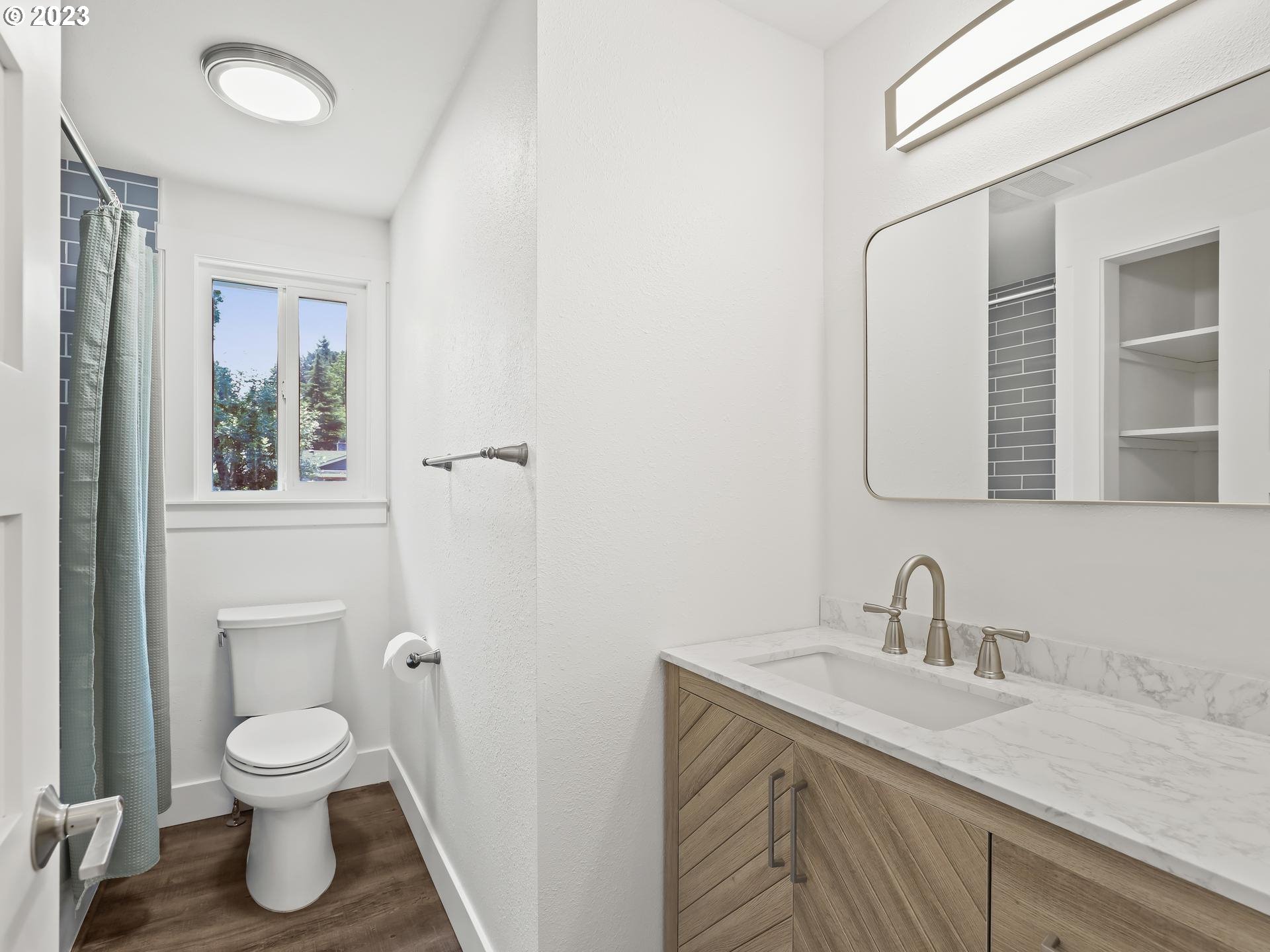 19650 Southwest Celebrity Street Beaverton, OR 97078 - Photo 20 of 47 a bathroom with a toilet sink a mirror and vanity