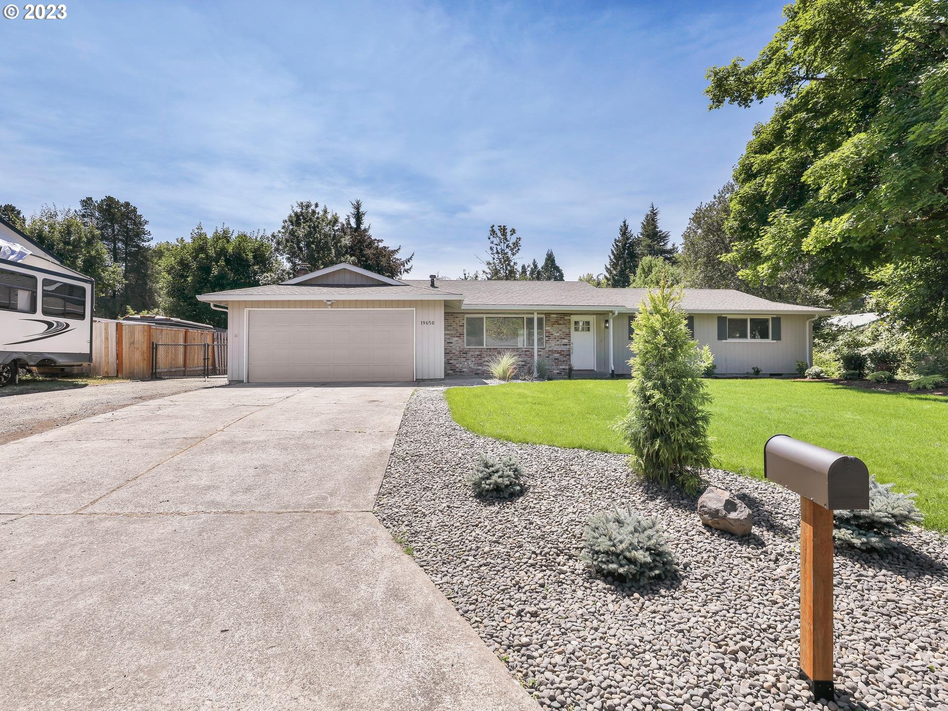 19650 Southwest Celebrity Street Beaverton, OR 97078 - Photo 2 of 47 a view of a house with backyard and a garden