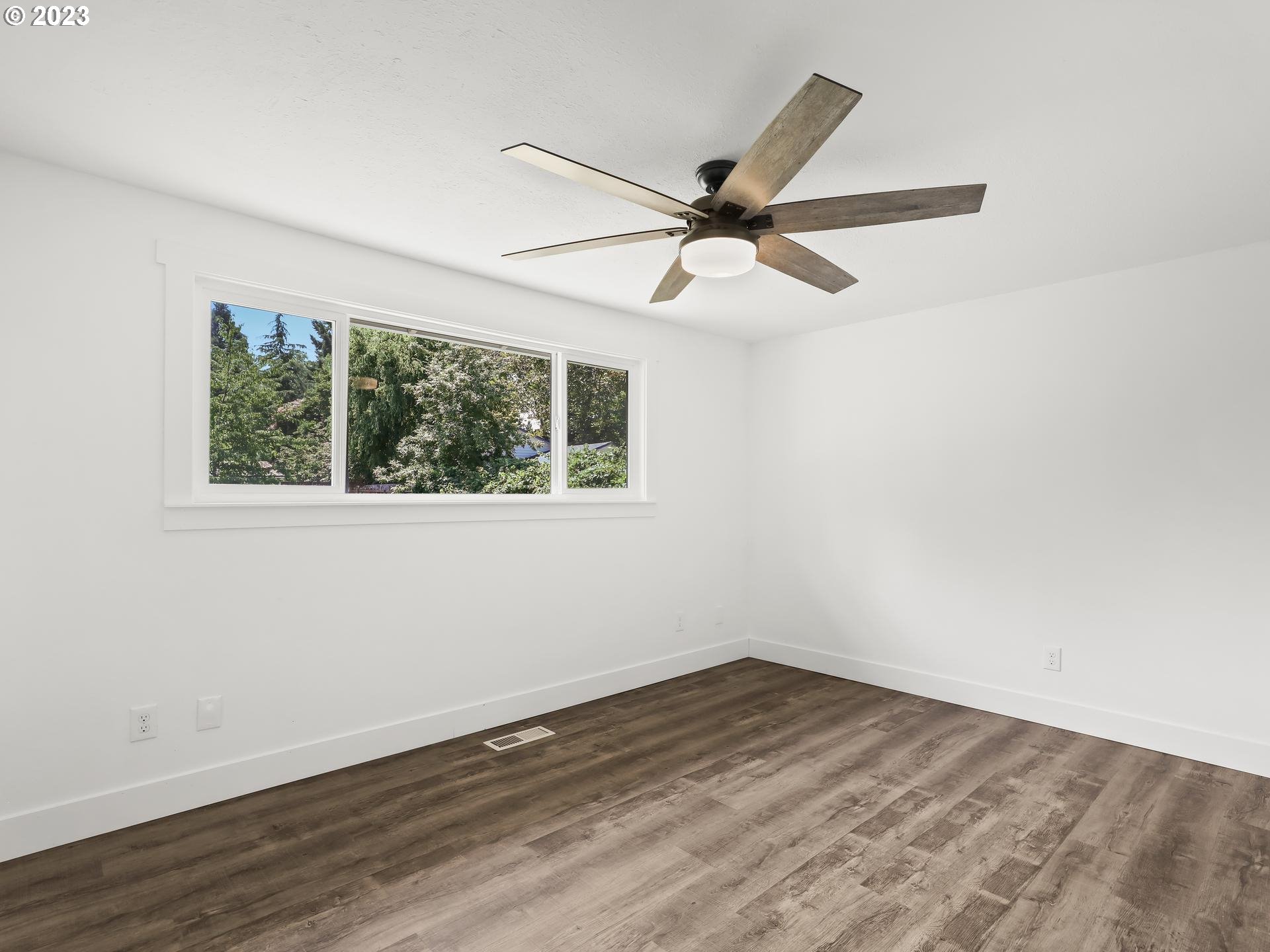 19650 Southwest Celebrity Street Beaverton, OR 97078 - Photo 21 of 47 a view of empty room with wooden floor and fan