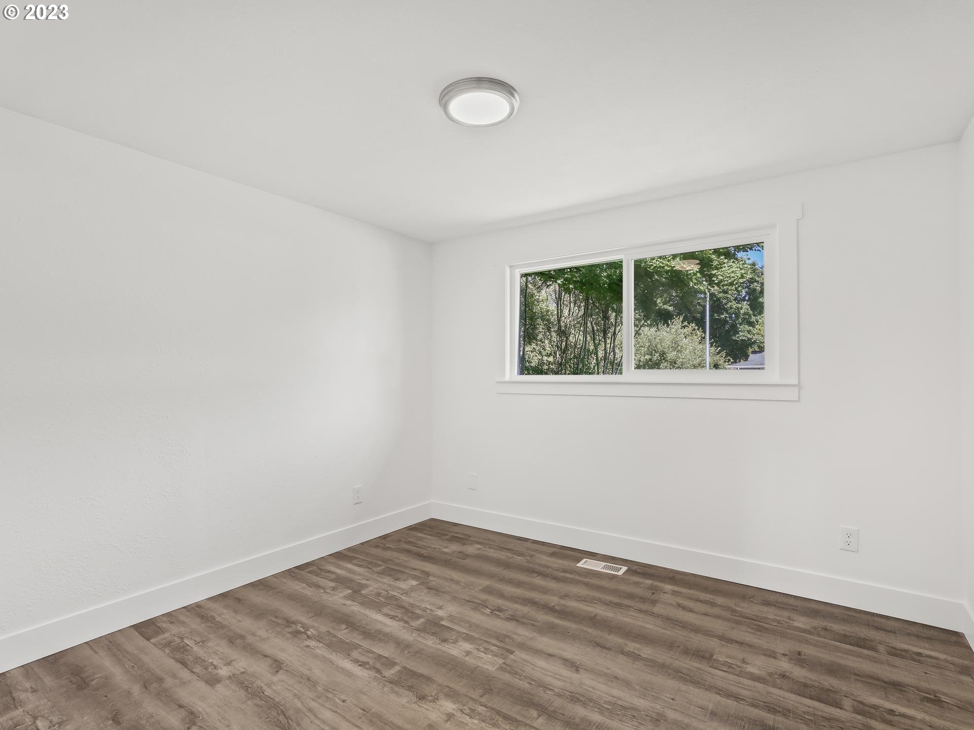 19650 Southwest Celebrity Street Beaverton, OR 97078 - Photo 26 of 47 an empty room with wooden floor and windows