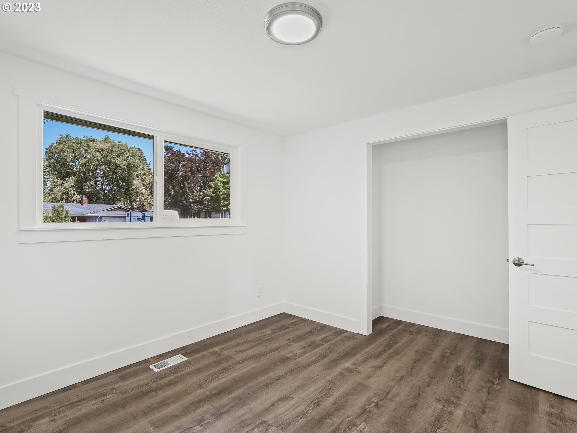 19650 Southwest Celebrity Street Beaverton, OR 97078 - Photo 27 of 47 an empty room with wooden floor and windows