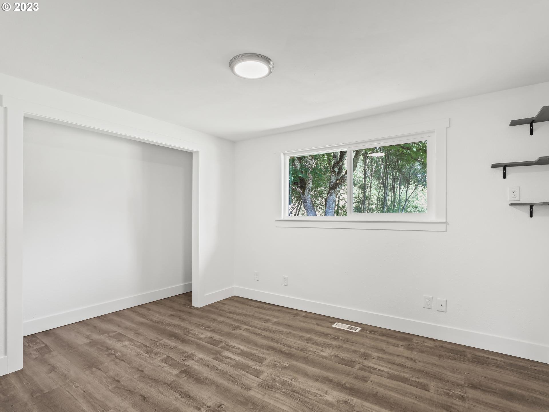 19650 Southwest Celebrity Street Beaverton, OR 97078 - Photo 29 of 47 a view of an empty room with wooden floor and a window