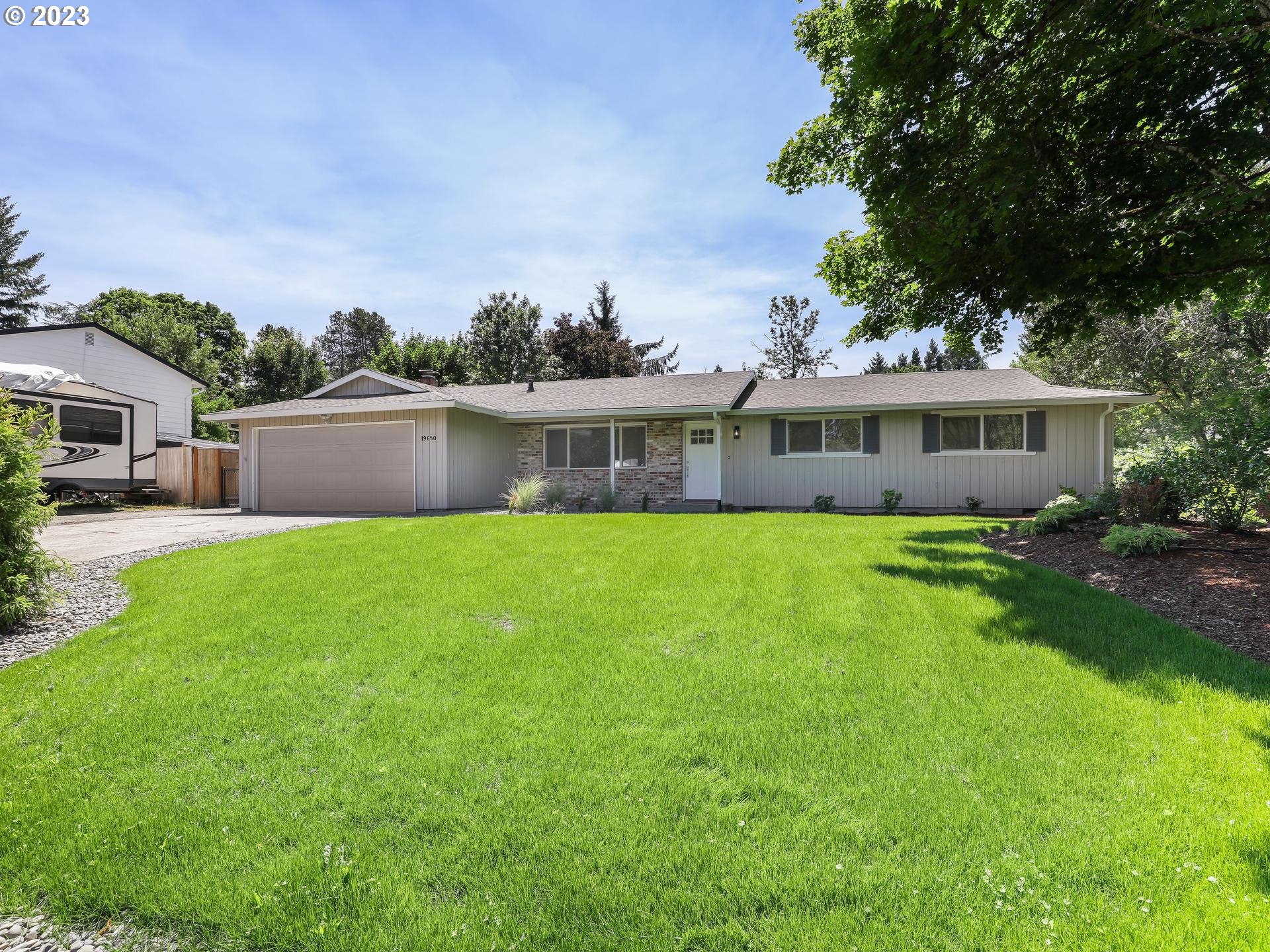 19650 Southwest Celebrity Street Beaverton, OR 97078 - Photo 3 of 47 a view of house with a yard