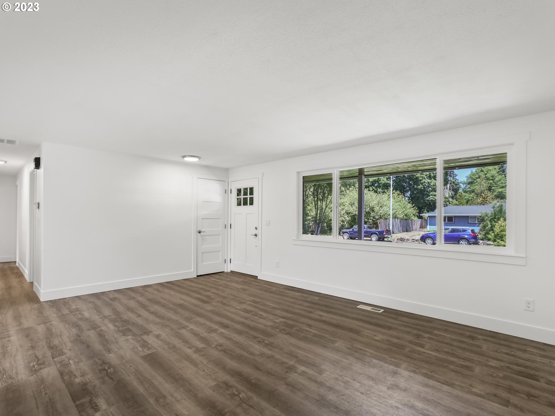 19650 Southwest Celebrity Street Beaverton, OR 97078 - Photo 4 of 47 a view of a big room with wooden floor and windows