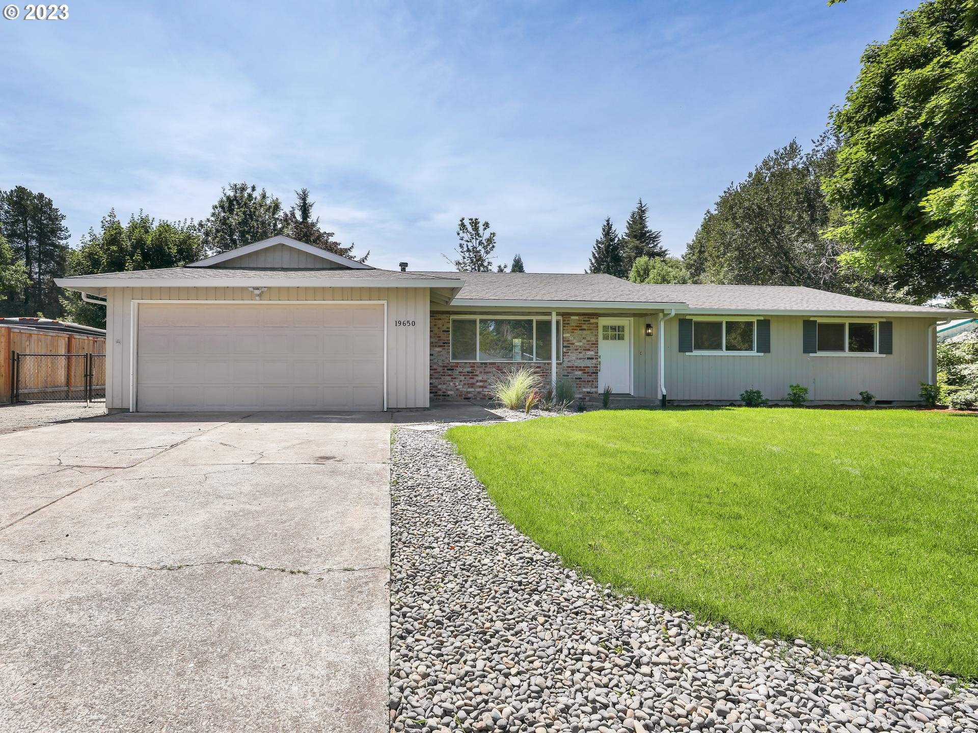 19650 Southwest Celebrity Street Beaverton, OR 97078 - Photo 47 of 47 a front view of a house with a garden and yard