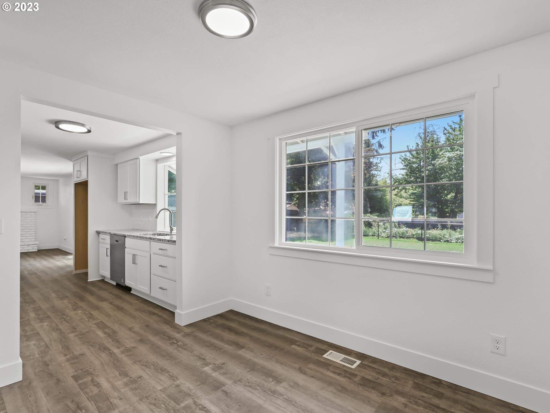 19650 Southwest Celebrity Street Beaverton, OR 97078 - Photo 7 of 47 an empty room with windows and cabinet