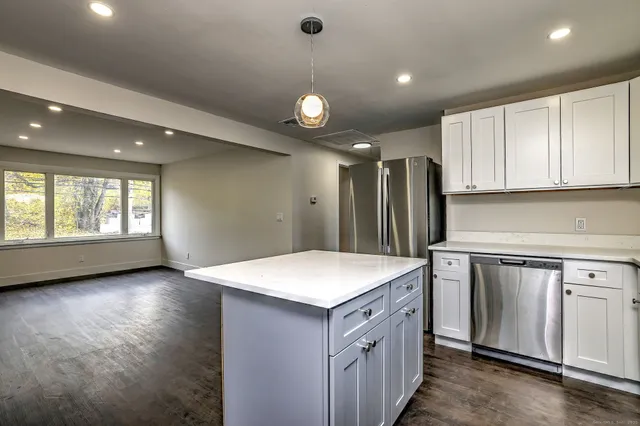 a kitchen that has a sink in it and a window