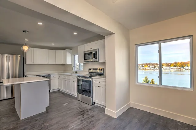 a kitchen with a stove a sink and a refrigerator