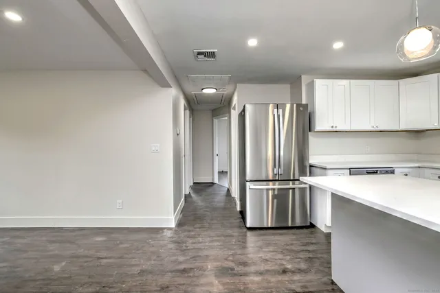 a kitchen with stainless steel appliances a refrigerator and a stove top oven