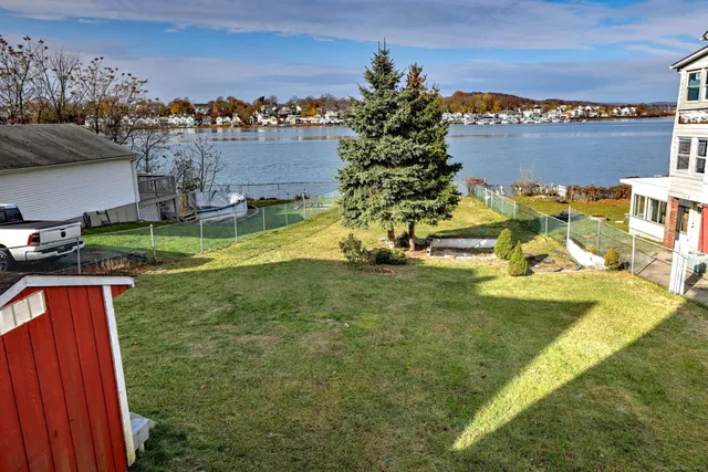 an aerial view of a house with yard swimming pool and outdoor seating