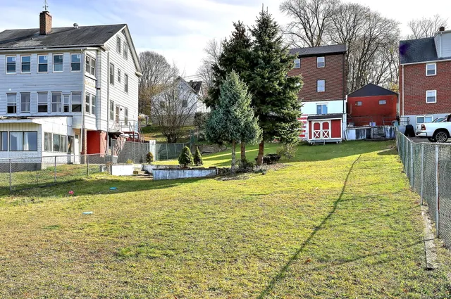 a swimming pool with outdoor seating and yard