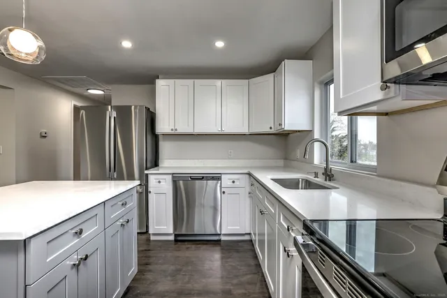 a kitchen with a sink stove and cabinets