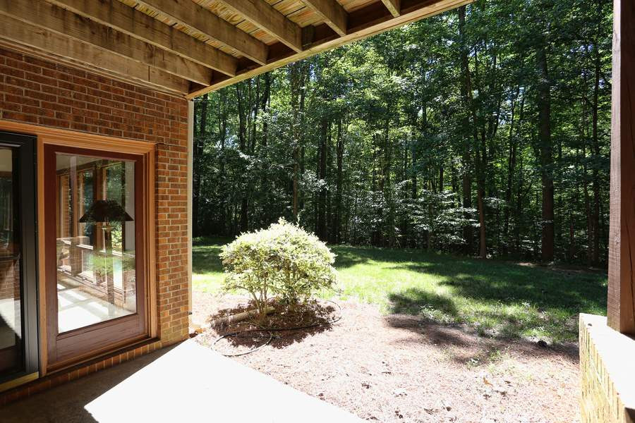 10420 Whitestone Road Raleigh, NC 27615 - Photo 24 of 24 Two doors leading to the backyard! One from the family room and one from the storage space in basement. Can't you imagine a hammock located on this patio! Basement patio