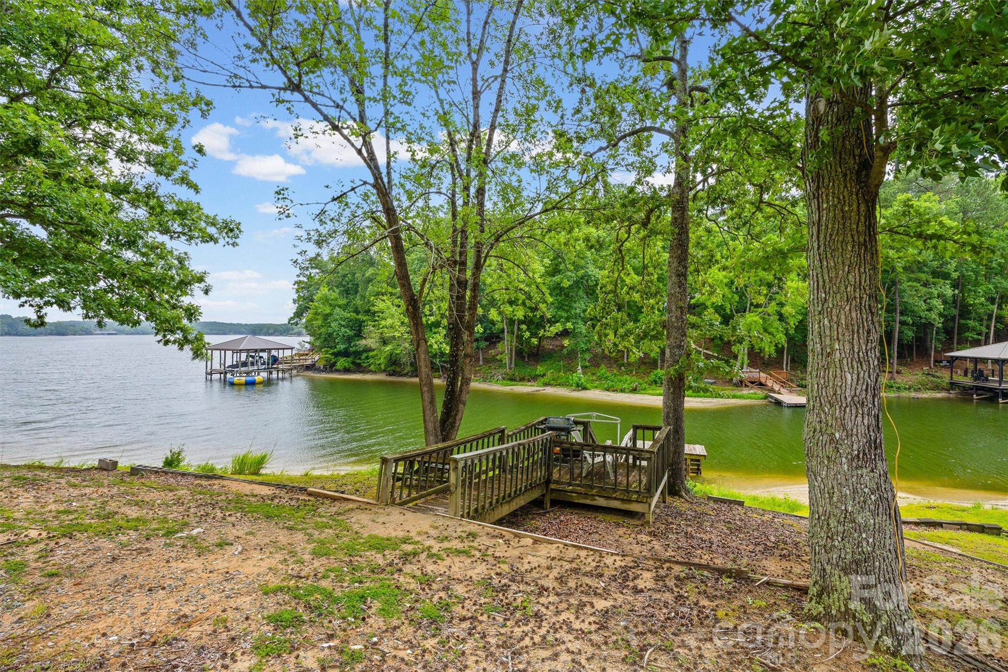 2071 Chameleon Road, Unit 156 York, SC 29745 - Photo 29 of 46 a view of a lake with a yard and large trees
