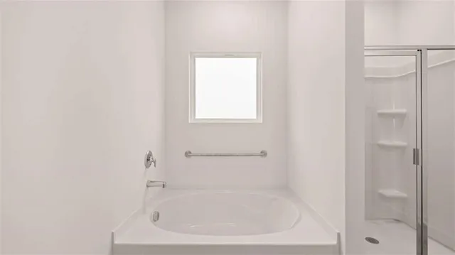 a white bath tub sitting next to a shower