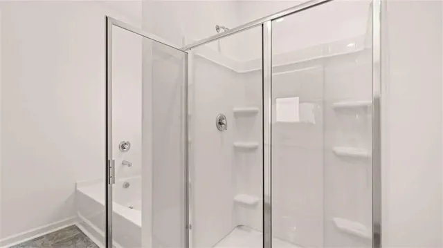 a bathroom with a glass shower door