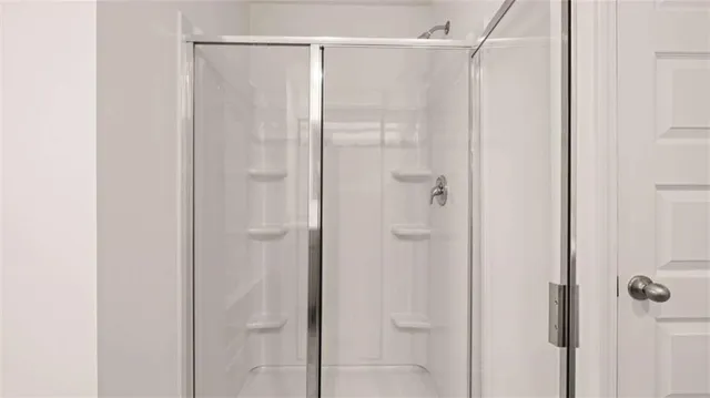a bathroom with a glass shower door