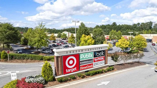 a street sign on a wall next to a road