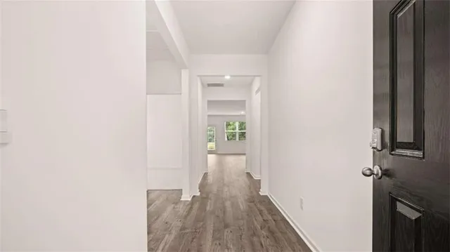 a view of a hallway with wooden floor