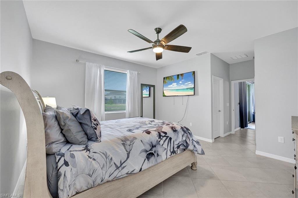 2622 Scarlet Way Naples, FL 34120 - Photo 9 of 24 a bed sitting in a bedroom next to a window