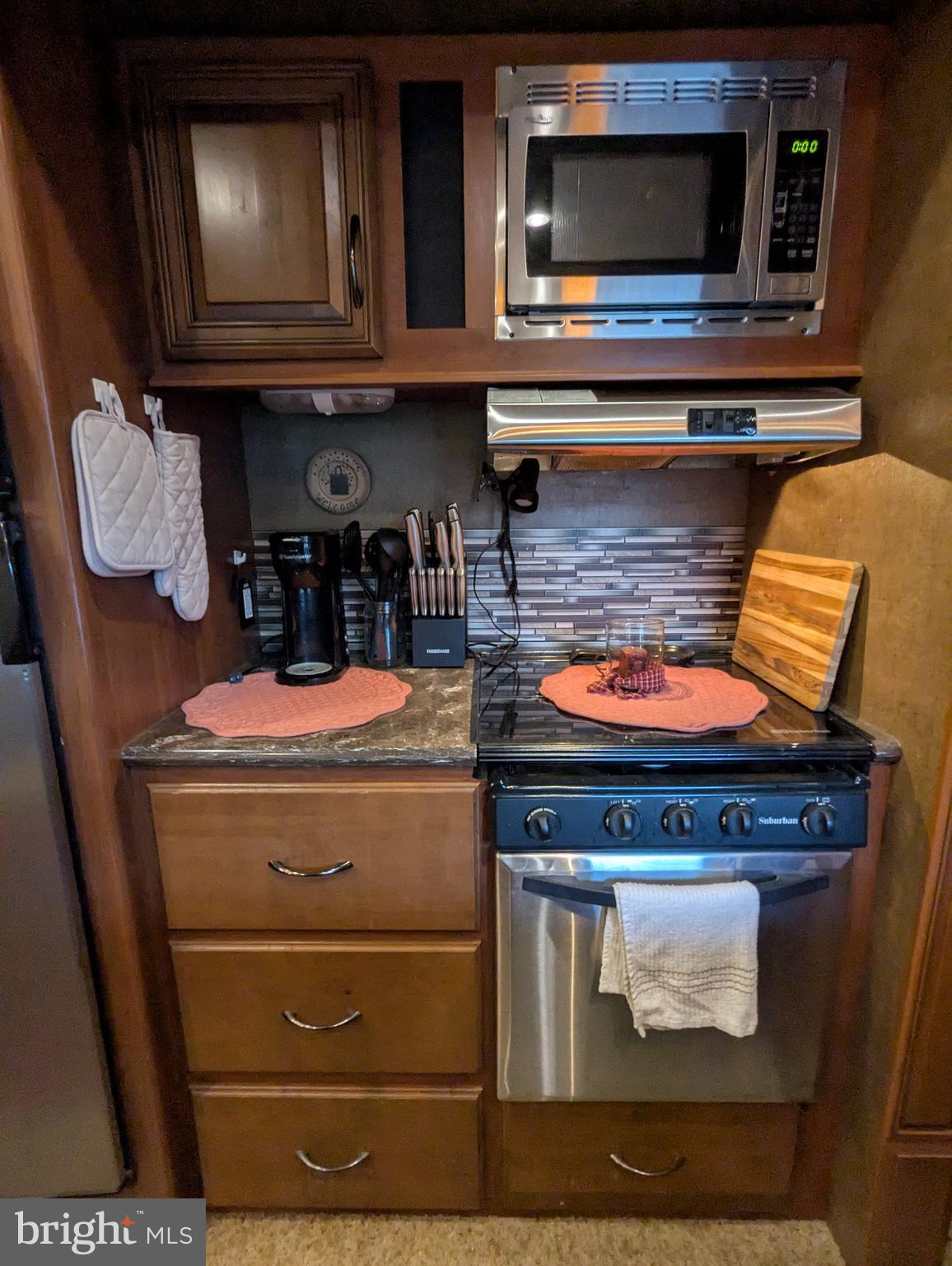 5 Bear Bottom Road Falling Waters, WV 25419 - Photo 19 of 27 a kitchen with wooden cabinets and a stove top oven
