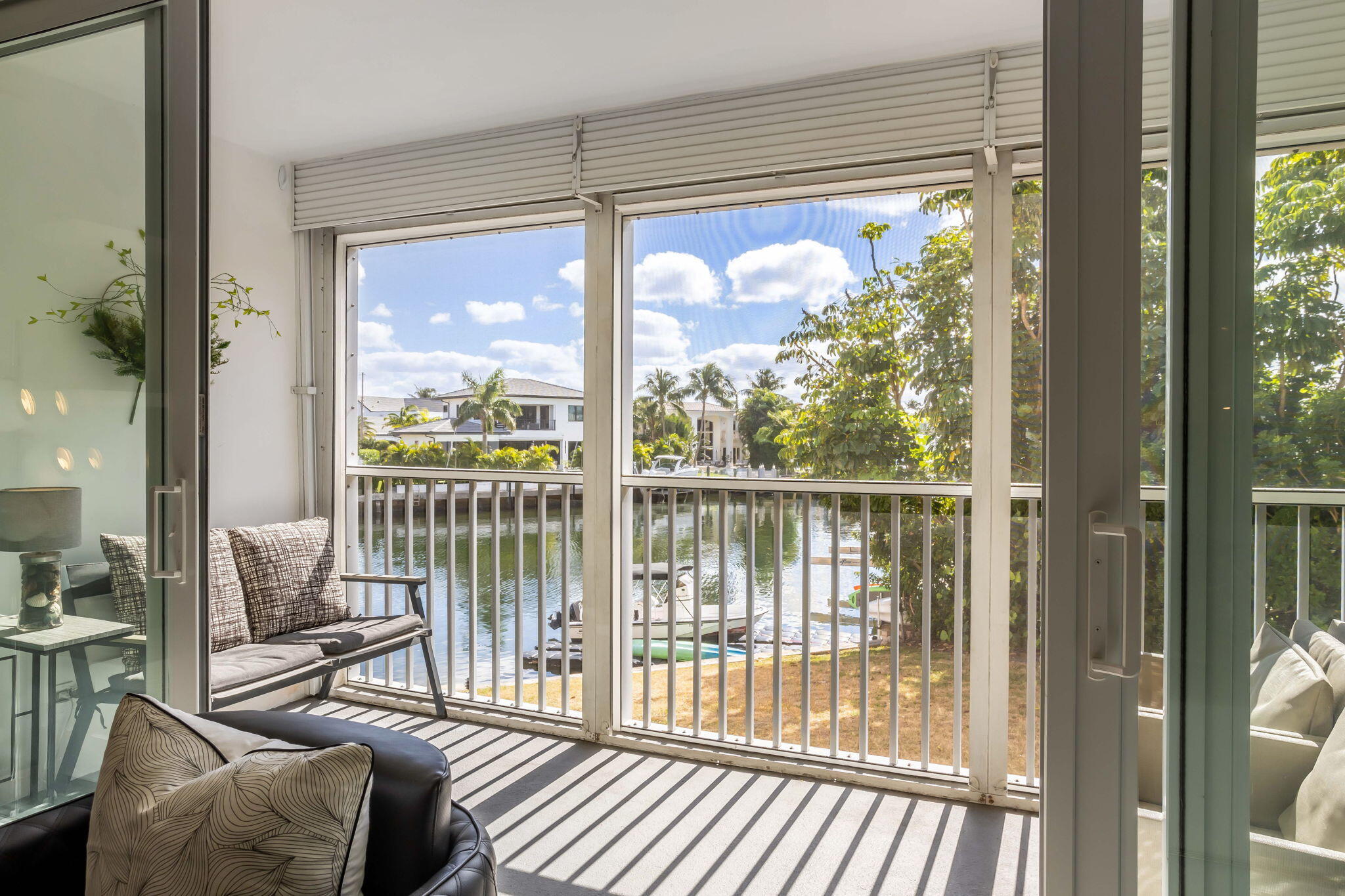 698 Northeast Spanish River Boulevard, Unit 24 Boca Raton, FL 33431 - Photo 11 of 25 a view of a room with balcony and wooden floor